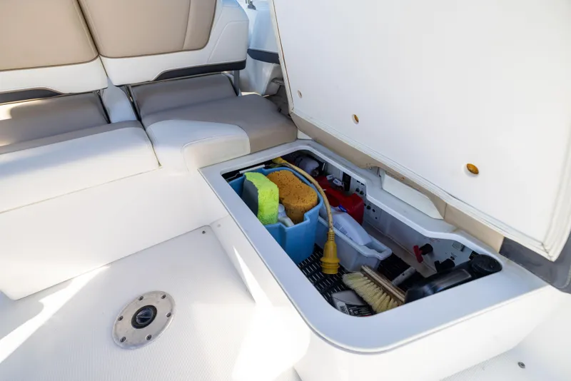 Slide: The Image of 2017 Formula 330 Crossover Bowrider storage compartment with cleaning supplies. - 48