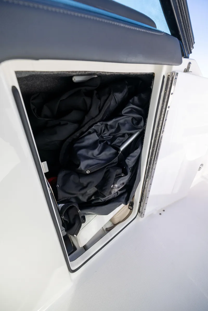 Slide: The Image of Storage compartment on 2017 Formula 330 Crossover Bowrider, featuring black gear inside. - 49