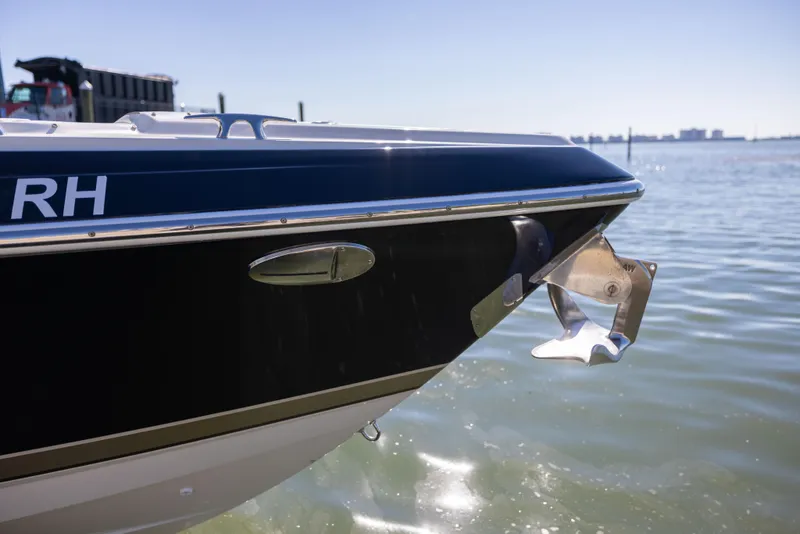 Slide: The Image of 2017 Formula 330 Crossover Bowrider boat anchored in calm waters. - 7