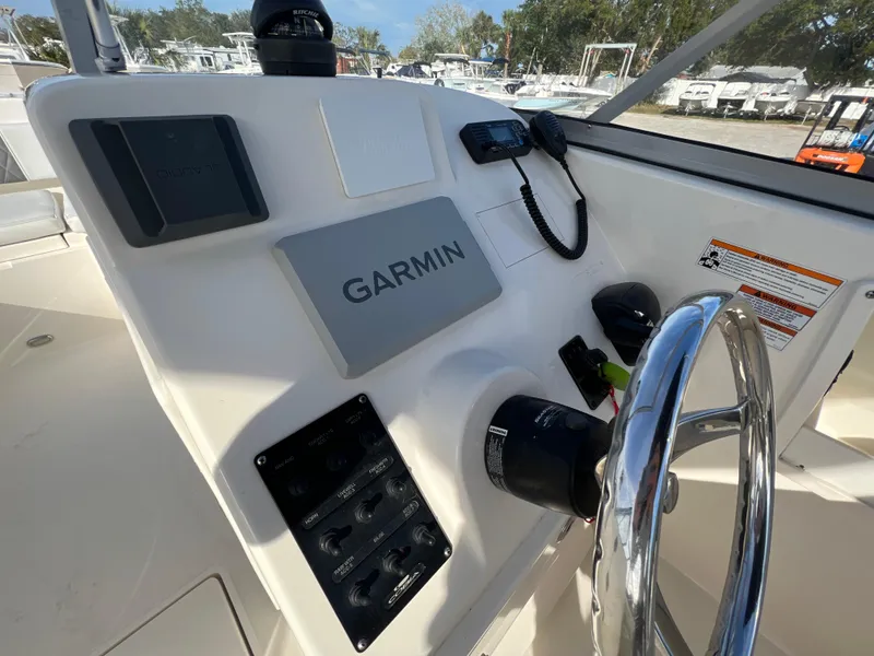 Slide: The Image of 2023 Cobia 220 Dual Console boat dashboard with Garmin navigation system. - 15