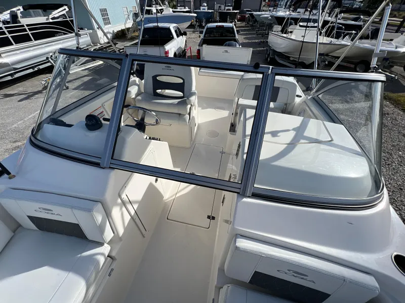 Slide: The Image of 2023 Cobia 220 Dual Console boat interior with seating and steering wheel. - 18
