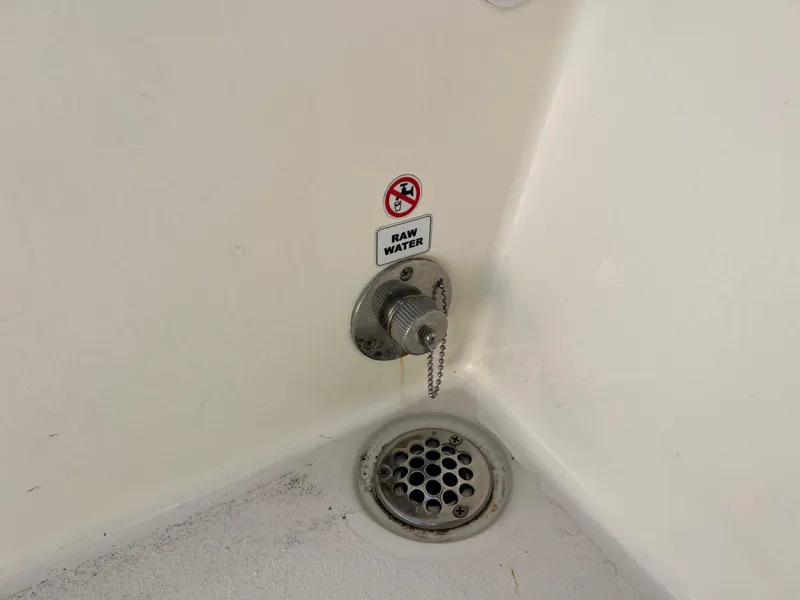 Slide: The Image of Raw water outlet and drain on 2023 Cobia 220 Dual Console boat. - 20