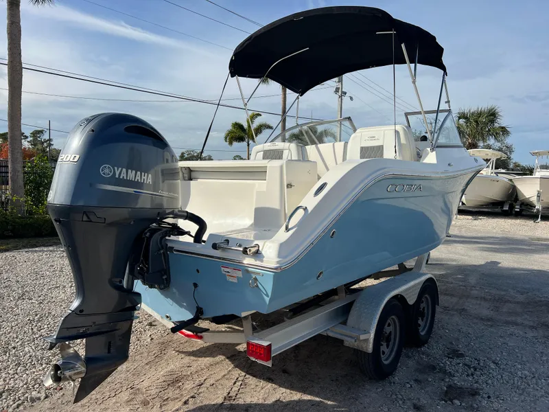 Slide: The Image of 2023 Cobia 220 Dual Console boat with Yamaha engine on trailer. - 7