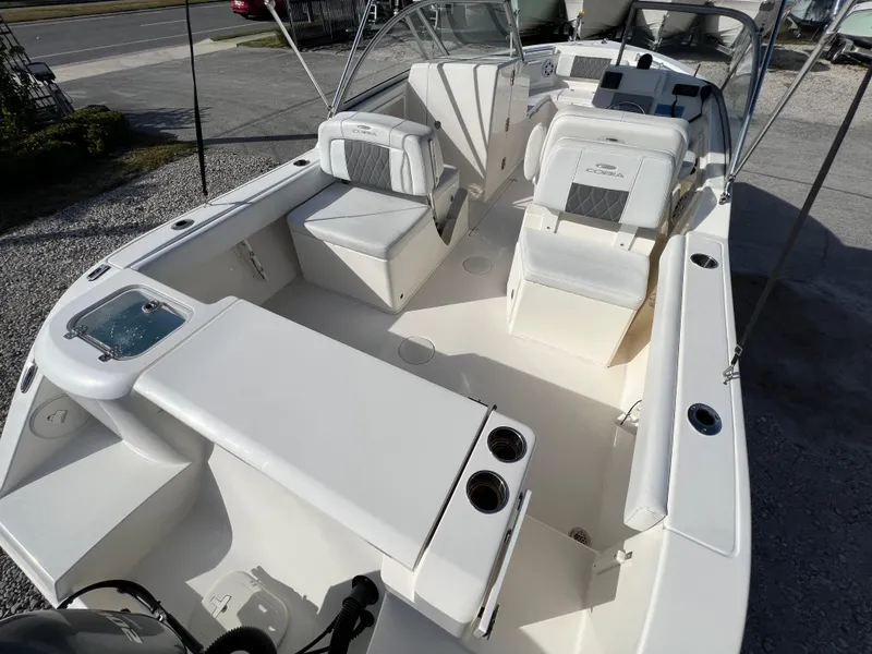 Slide: The Image of 2023 Cobia 220 Dual Console boat with spacious seating and modern design. - 8