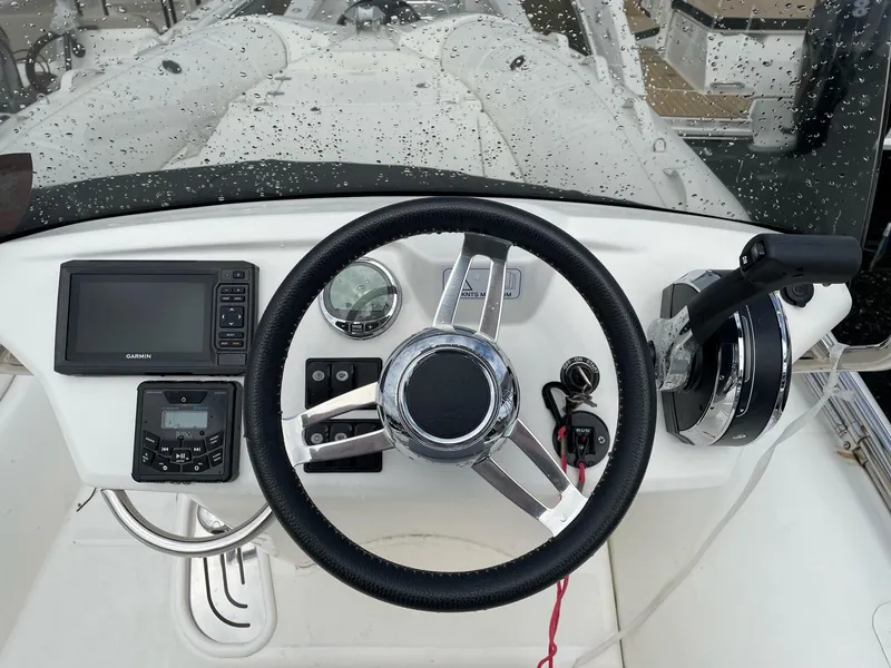 Slide: The Image of 2023 Zodiac N-ZO 680 boat dashboard with steering wheel and navigation controls. - 5