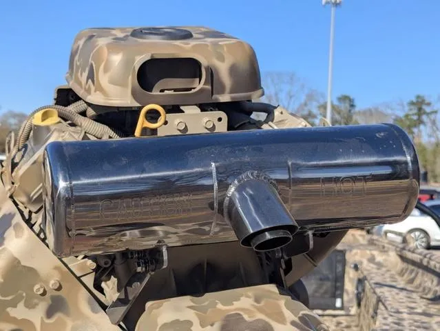 Slide: The Image of Camouflage-patterned Excel 1854 Shallow Water F4 boat engine, featuring a prominent exhaust system. - 14