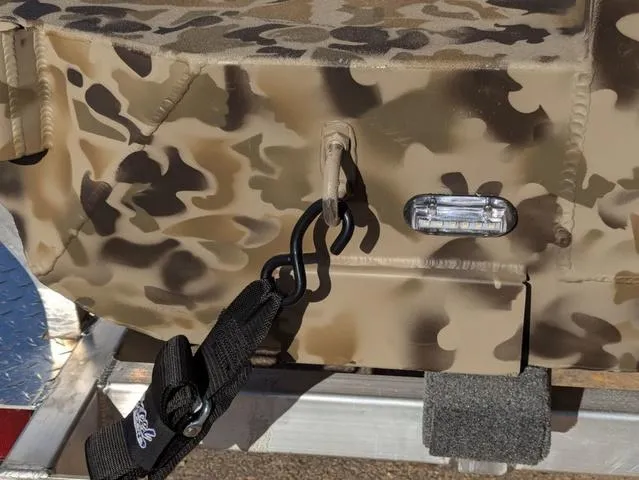 Slide: The Image of Camo-patterned 2025 Excel 1854 Shallow Water F4 boat detail with hook and light. - 18