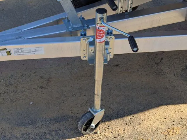 Slide: The Image of Trailer jack on Excel 1854 Shallow Water F4, 2025 model, with wheel on sandy ground. - 24
