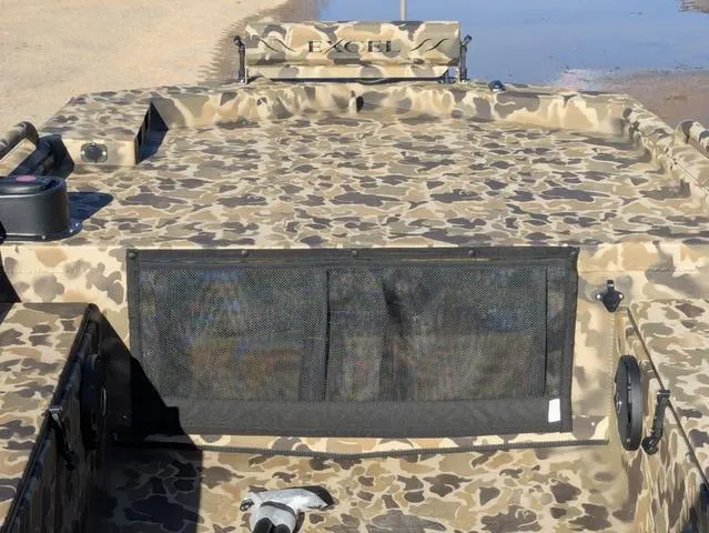 Slide: The Image of Camouflage-patterned 2025 Excel 1854 Shallow Water F4 boat on sandy shore. - 28