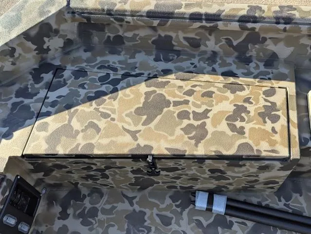 Slide: The Image of Camo interior of 2025 Excel 1854 Shallow Water F4 boat, featuring storage compartment. - 34