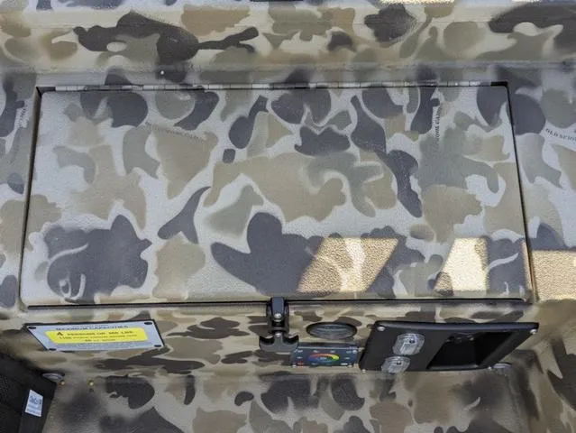 Slide: The Image of Camouflage interior of 2025 Excel 1854 Shallow Water F4 boat, featuring control panel and storage. - 36