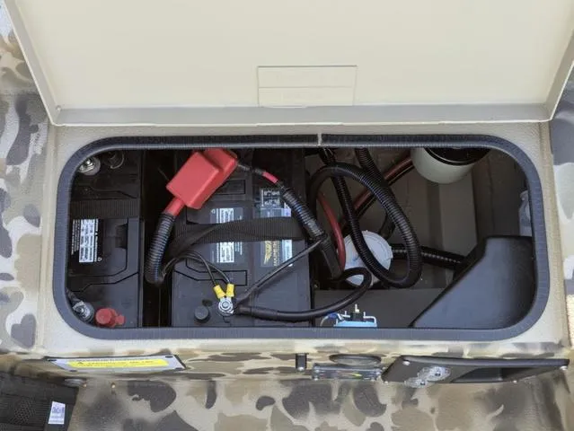 Slide: The Image of Battery compartment of 2025 Excel 1854 Shallow Water F4 boat, showing wiring and connections. - 41