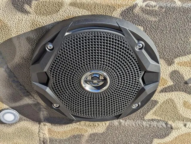 Slide: The Image of Speaker mounted on Excel 1854 Shallow Water F4 boat, 2025 model, with camouflage background. - 44