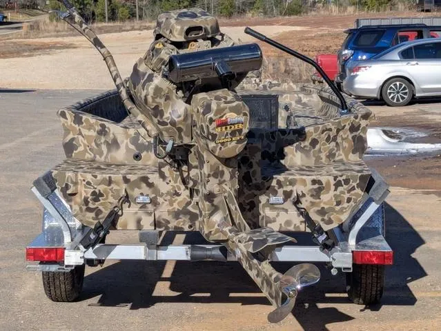 Slide: The Image of 2025 Excel 1854 Shallow Water F4 boat with camouflage design on a trailer. - 5