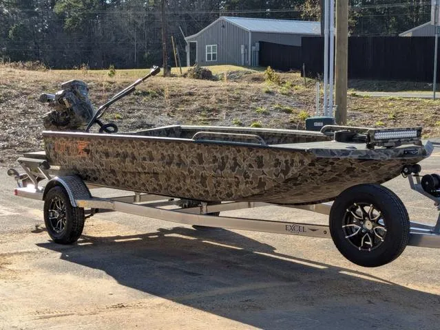 Slide: The Image of 2025 Excel 1854 Shallow Water F4 boat on trailer, camo design, outdoor setting. - 8