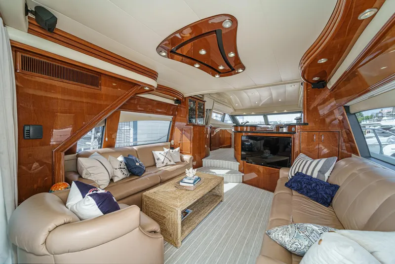 Slide: The Image of Luxurious interior of a 2004 Marquis 59 yacht with elegant seating and wood finishes. - 11