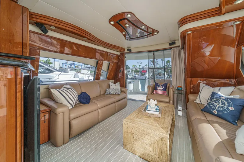 Slide: The Image of Luxurious 2004 Marquis 59 yacht interior with leather sofas and nautical decor. - 13