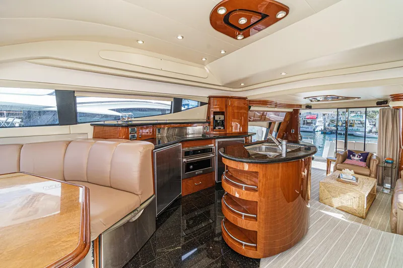 Slide: The Image of Luxurious interior of a 2004 Marquis 59 yacht with modern kitchen and seating area. - 16