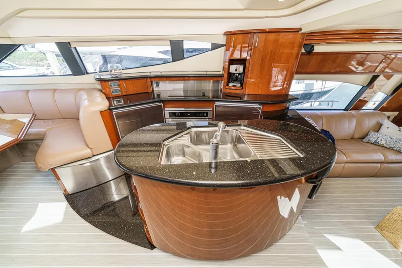 Slide: The Image of Luxurious interior of a 2004 Marquis 59 yacht with modern kitchen and seating area. - 17