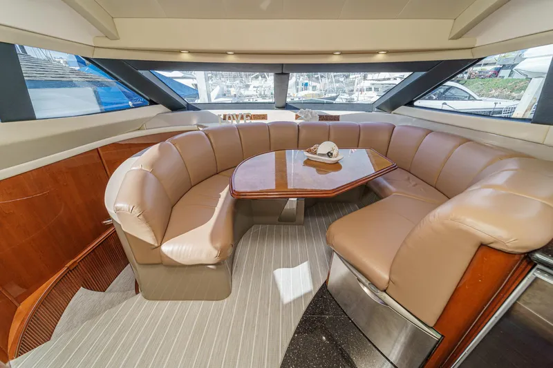 Slide: The Image of Luxurious interior of a 2004 Marquis 59 yacht with plush seating and elegant table. - 21