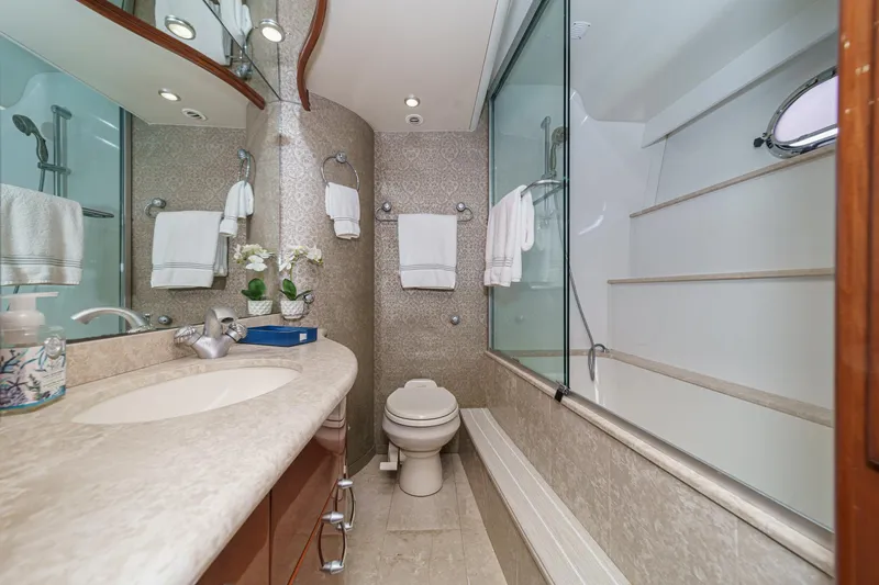 Slide: The Image of Luxurious bathroom in a 2004 Marquis 59 yacht with elegant fixtures and modern design. - 27
