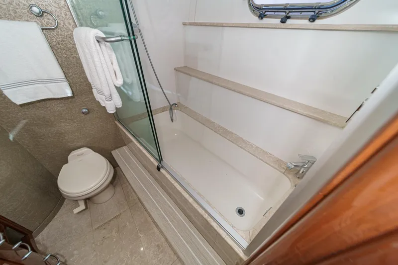 Slide: The Image of Luxurious 2004 Marquis 59 yacht bathroom with shower, toilet, and elegant design. - 29