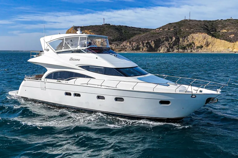 Slide: The Image of Luxurious 2004 Marquis 59 yacht cruising in scenic coastal waters. - 3