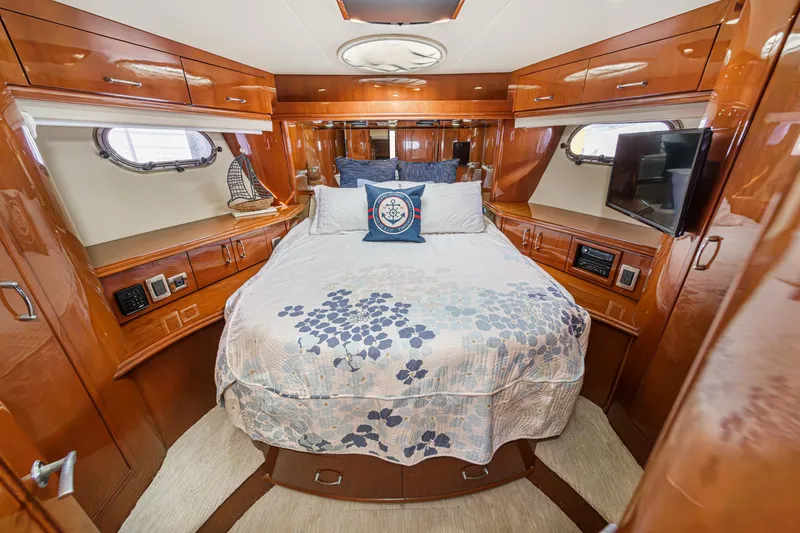 Slide: The Image of Luxurious 2004 Marquis 59 yacht bedroom with elegant wood finish and cozy bedding. - 32