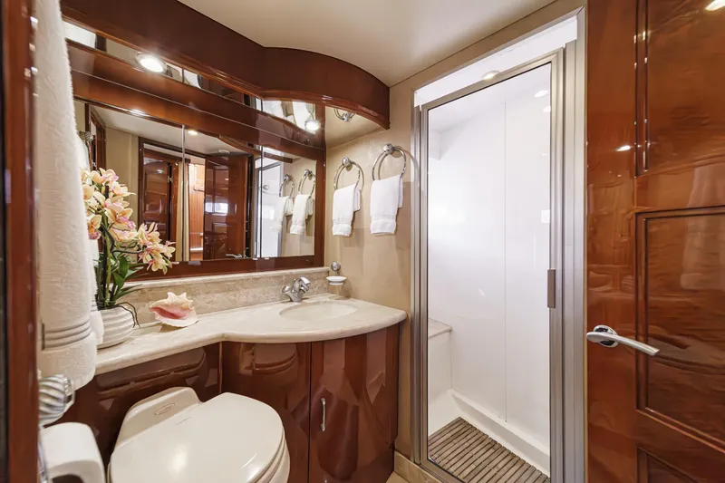 Slide: The Image of Luxurious 2004 Marquis 59 yacht bathroom with elegant wood finishes and modern amenities. - 34