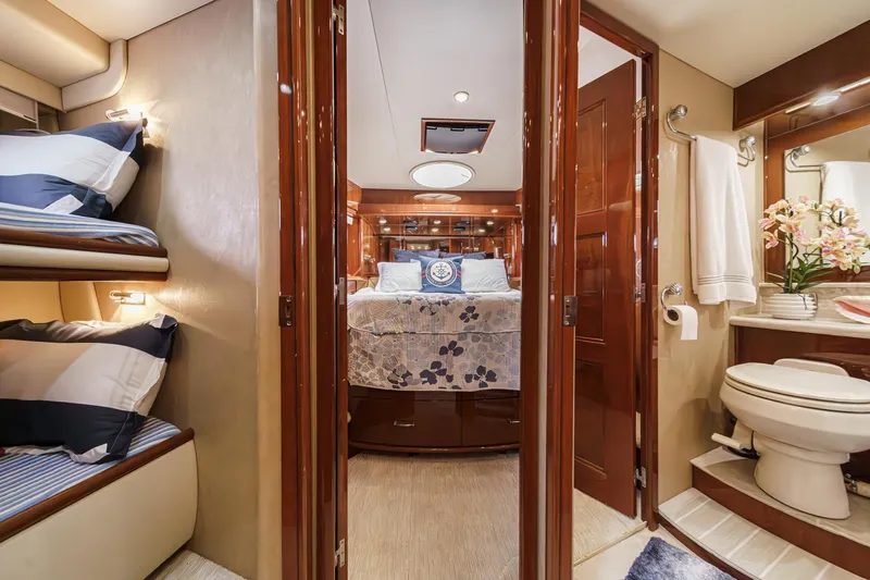 Slide: The Image of Luxurious interior of a 2004 Marquis 59 yacht featuring a bedroom and bathroom. - 35