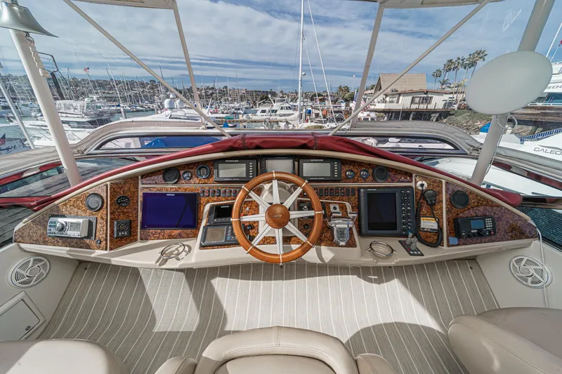 Slide: The Image of Helm of 2004 Marquis 59 yacht with navigation instruments and wooden steering wheel. - 38