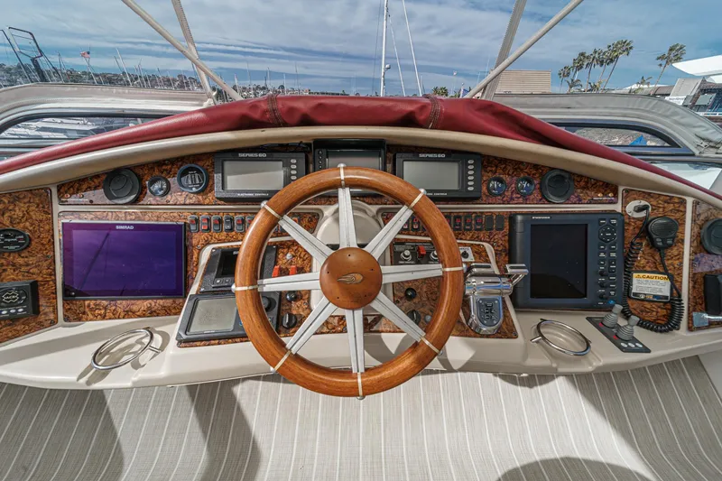Slide: The Image of 2004 Marquis 59 yacht helm with wooden steering wheel and navigation instruments. - 39
