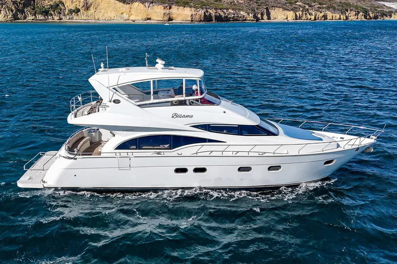 Slide: The Image of 2004 Marquis 59 yacht cruising on blue ocean waters. - 4