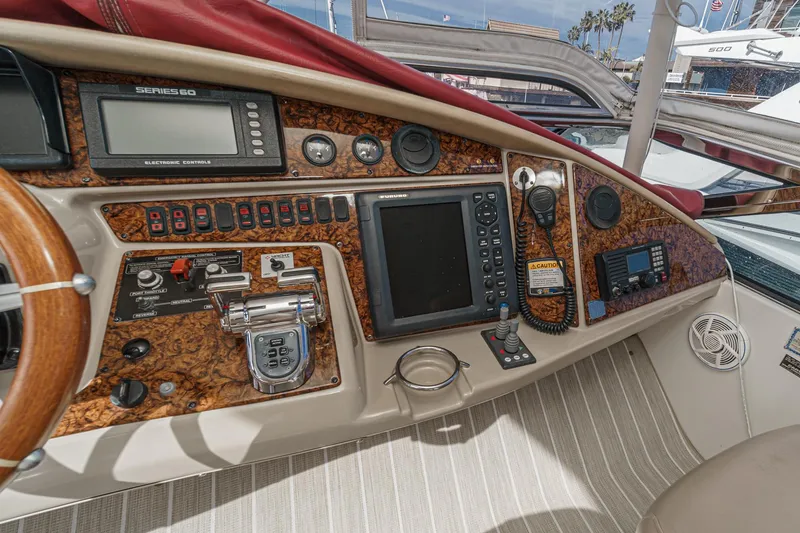 Slide: The Image of 2004 Marquis 59 yacht dashboard with navigation controls and instruments. - 41