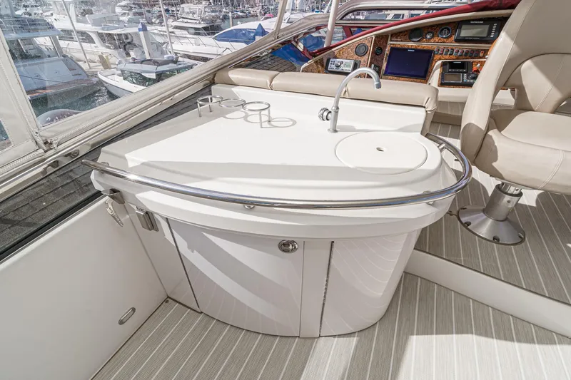 Slide: The Image of Luxurious 2004 Marquis 59 yacht interior with sleek kitchenette and modern helm controls. - 43