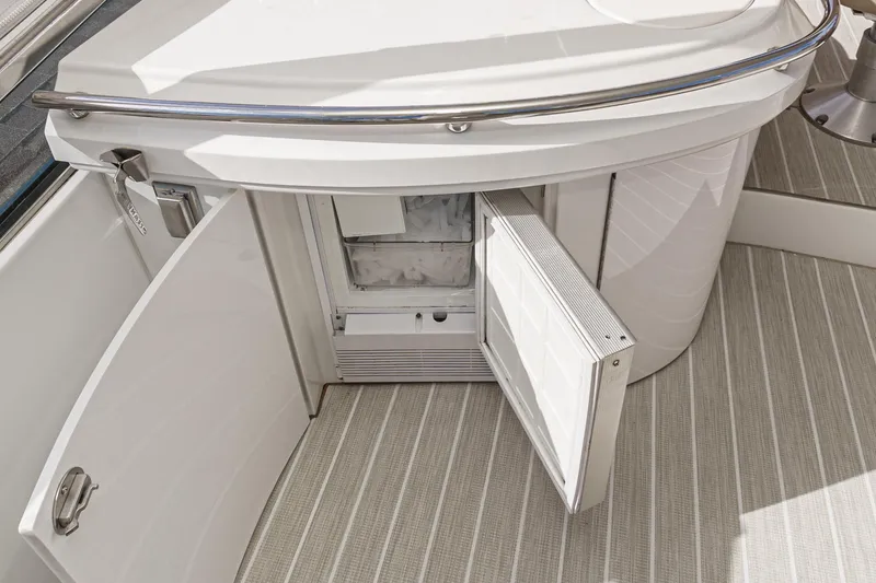 Slide: The Image of 2004 Marquis 59 yacht interior with open storage compartment and striped flooring. - 44