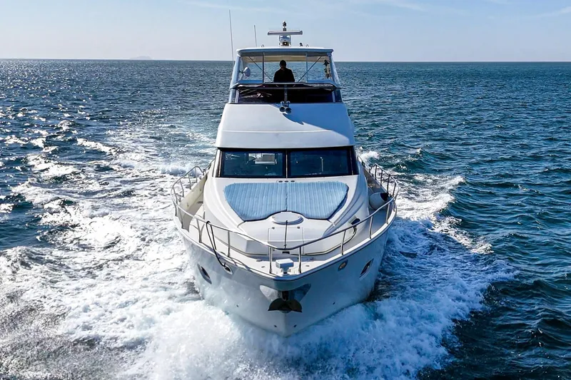 Slide: The Image of 2004 Marquis 59 yacht cruising on open sea, front view. - 6