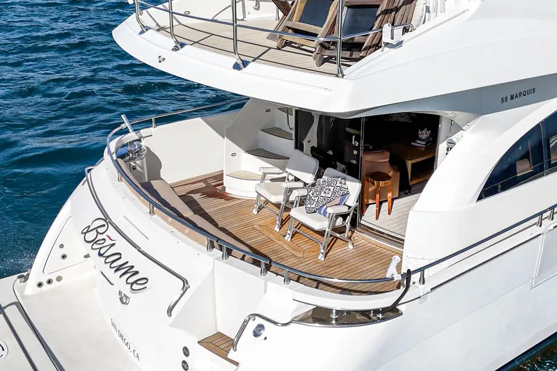 Slide: The Image of Luxury 2004 Marquis 59 yacht with elegant deck and seating area on the water. - 9