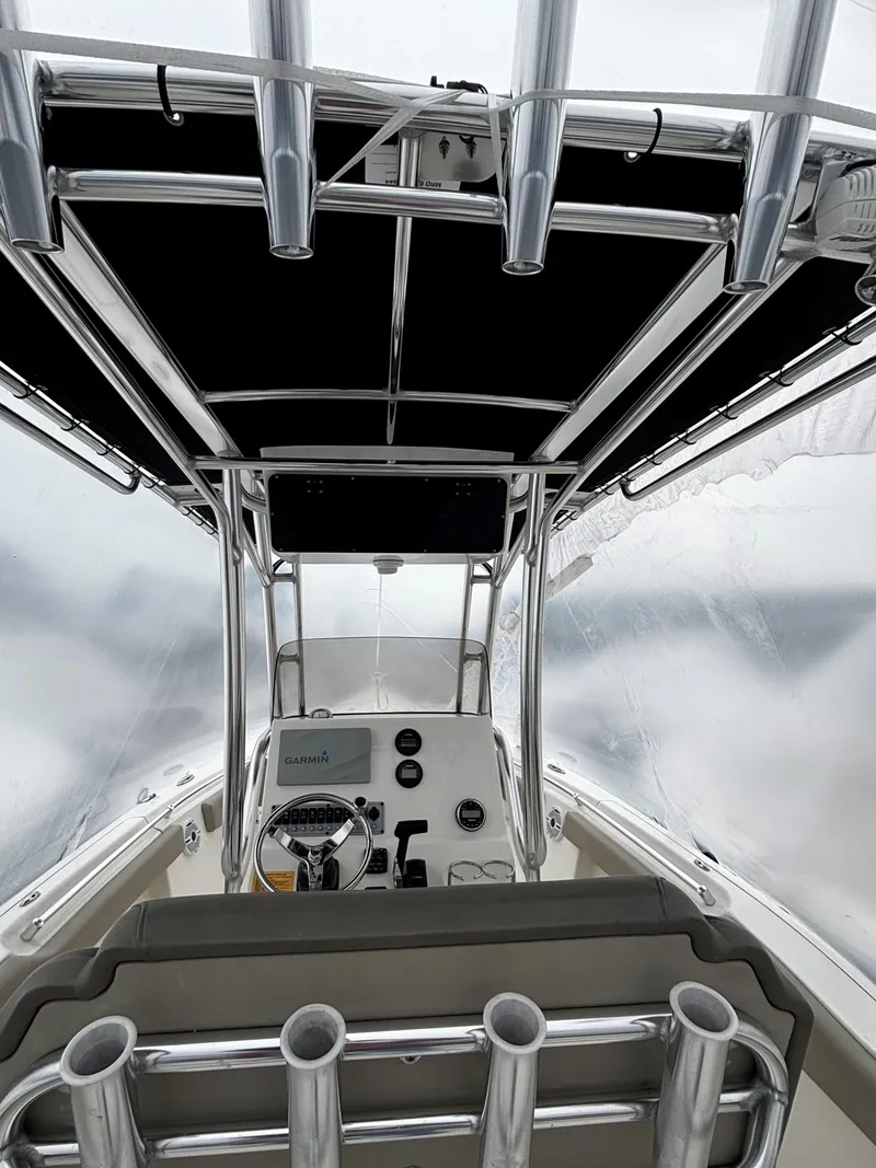 Slide: The Image of Interior view of 2023 Key West 239 FS boat cockpit with steering wheel and controls. - 2