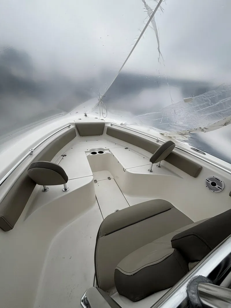 Slide: The Image of 2023 Key West 239 FS boat interior with seating and storage compartments. - 4