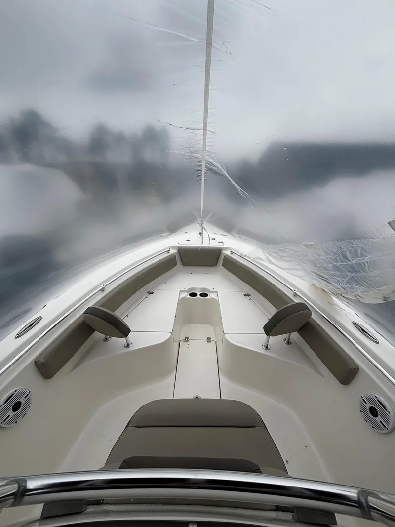 Slide: The Image of 2023 Key West 239 FS boat interior with seating and cloudy sky. - 5