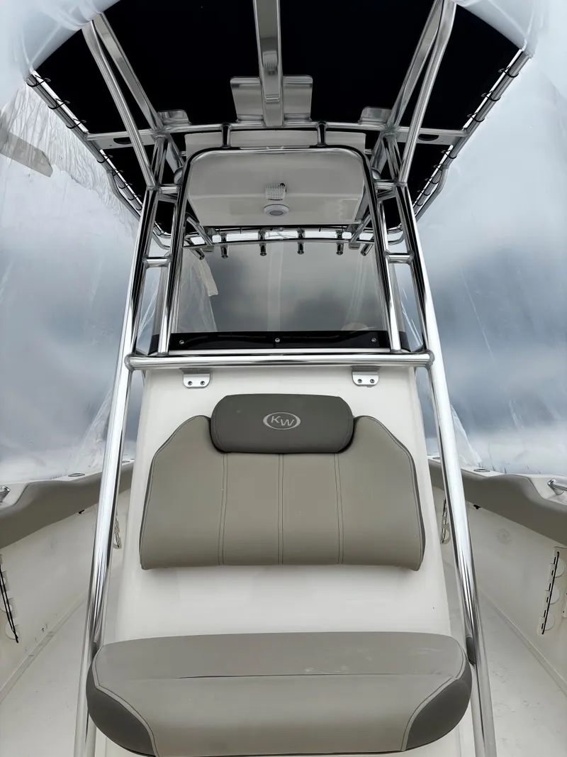 Slide: The Image of 2023 Key West 239 FS boat interior with sleek seating and stainless steel frame. - 7
