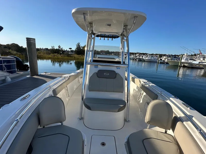 Slide: The Image of 2023 Key West 239 FS boat docked in a serene marina setting. - 2