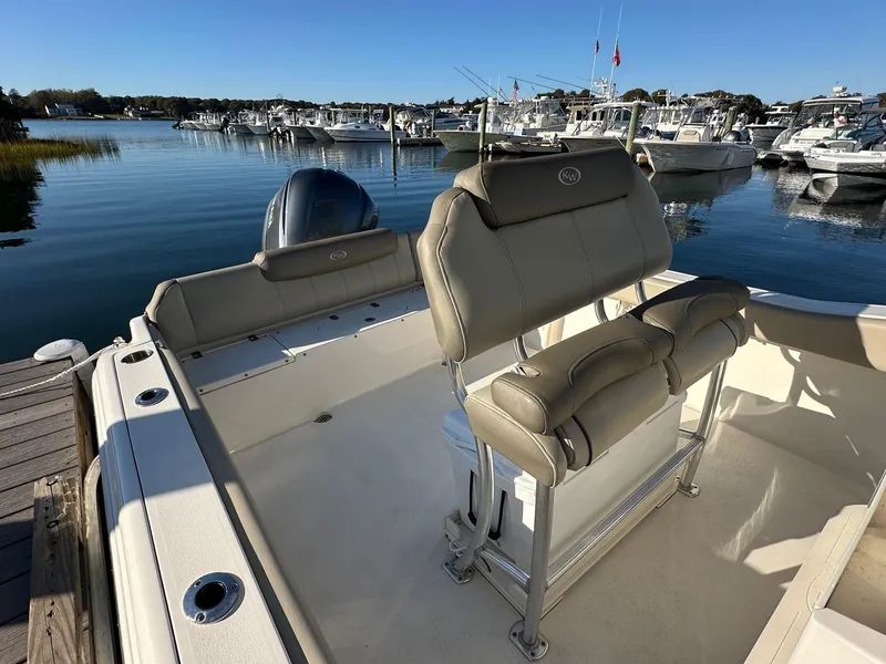 Slide: The Image of 2023 Key West 239 FS boat interior at marina, featuring comfortable seating and scenic water view. - 4