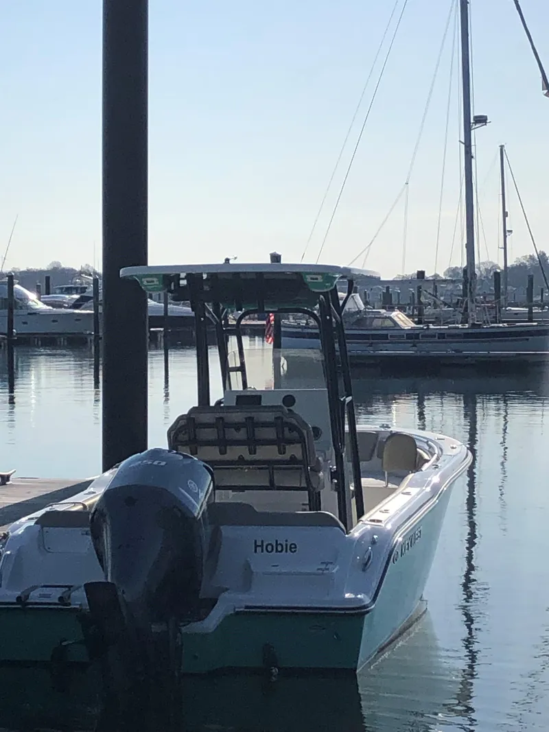 Slide: The Image of 2024 Key West 239 FS boat docked in a marina, calm water reflections. - 3