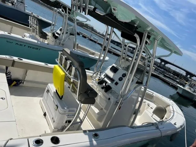 Slide: The Image of 2022 Key West 219 FS boat docked at marina, featuring center console and seating. - 3