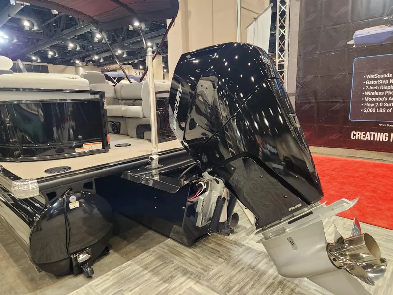 Slide: The Image of 2025 Regency 250 LE3 boat with powerful outboard motor at indoor exhibition. - 2