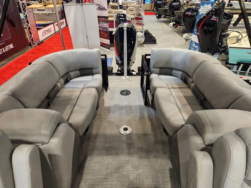 Slide: The Image of Luxurious seating on 2025 Regency 250 LE3 pontoon boat at a boat show. - 5