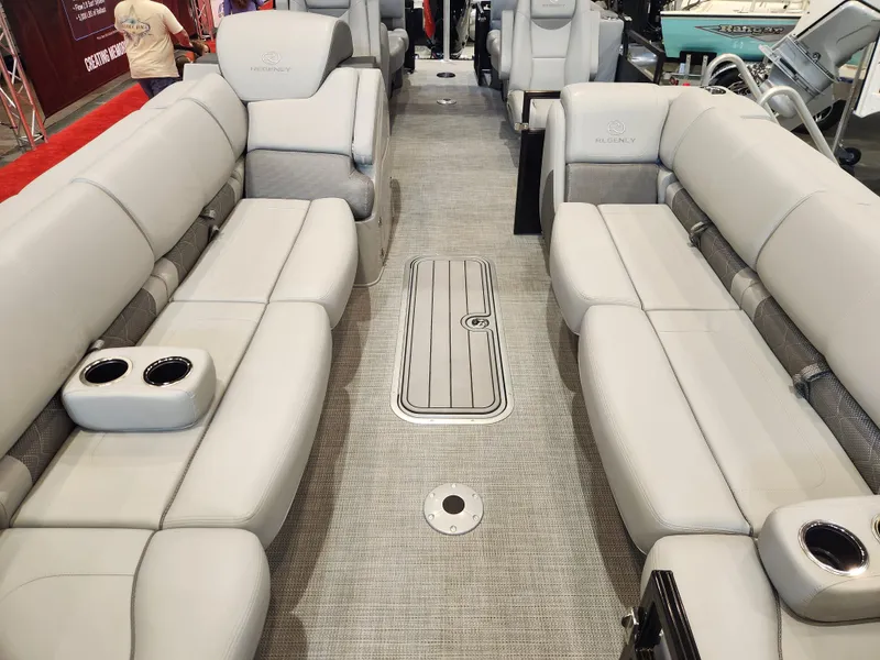 Slide: The Image of Luxurious interior of 2025 Regency 250 LE3 pontoon boat with plush seating and cup holders. - 6