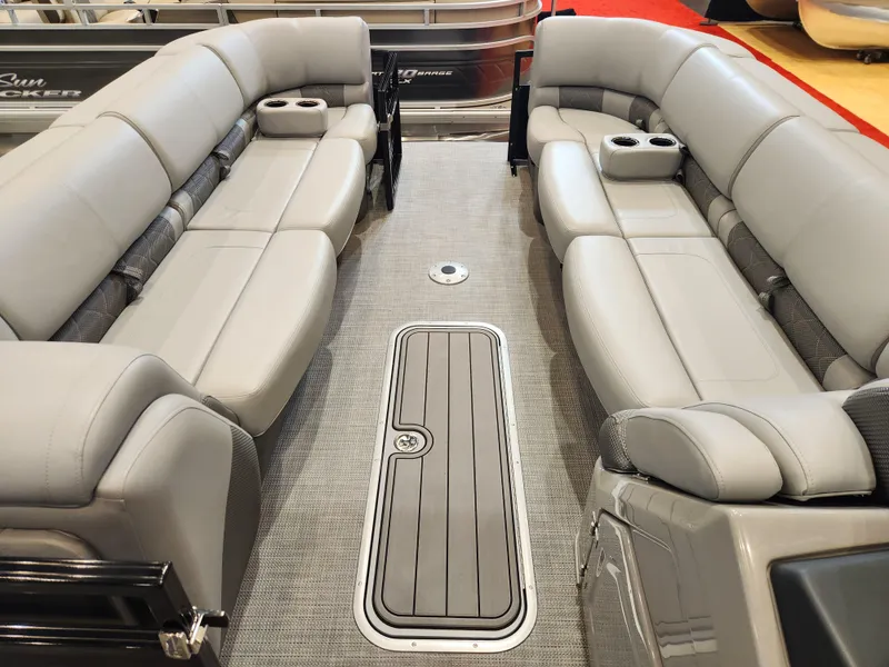 Slide: The Image of Luxurious interior of 2025 Regency 250 LE3 pontoon boat with plush seating and cup holders. - 9